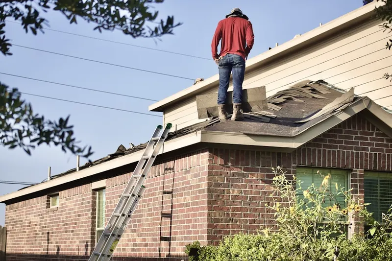 Professional roofer working on a residential roof in Damascus View